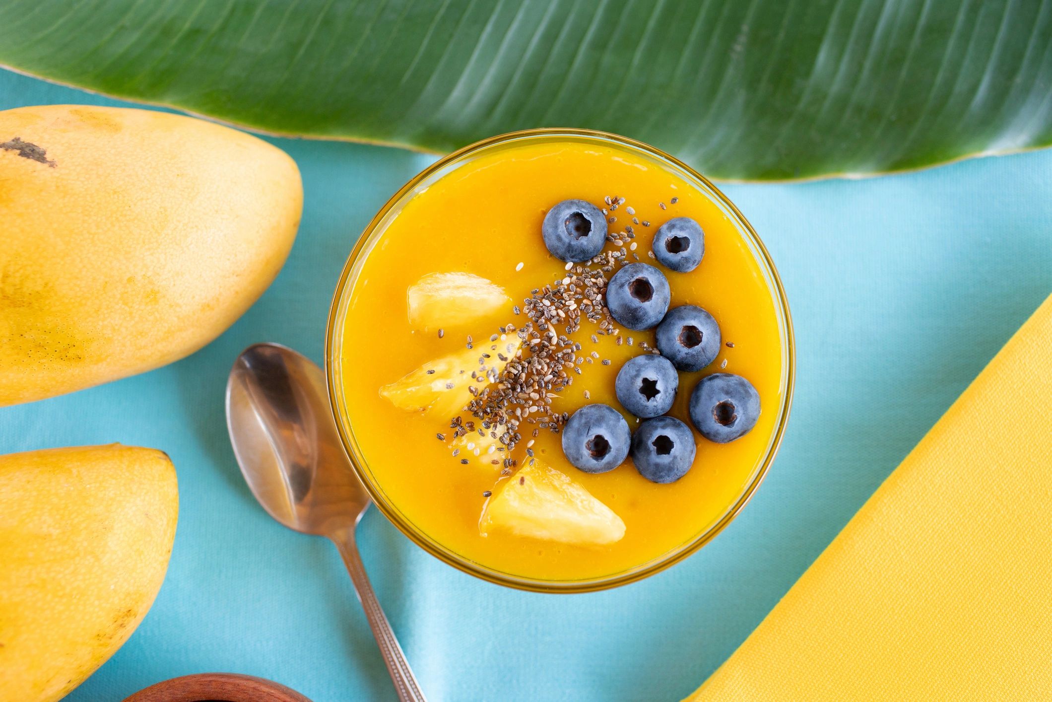 Mango turmeric smoothie bowl with blueberries, pineapple and chia seeds